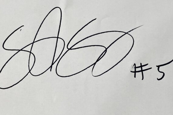 Ein fettes, schwarzes, unleserliches Autogramm ist auf weißem Papier geschrieben. Rechts neben der Unterschrift steht mit schwarzer Tinte der Text #5.