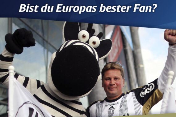 Ein Mann in einem Sporttrikot posiert mit einem Zebra-Maskottchen, beide halten Fahnen, unter einem Banner, das für das VELUX EHF Champions League FINAL4 wirbt, mit der Frage, ob Sie der beste Fan Europas sind.