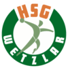 Das Logo der HSG Wetzlar zeigt einen stilisierten Handballspieler in Grün innerhalb eines grün-weißen Kreises, mit HSG in Orange oben und WETZLAR in weißer Schrift unten - perfekt für Fans, die auf der Suche nach THW Kiel handball auswärts Tickets sind.