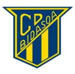 Ein blaues und gelbes schildförmiges Logo mit C.P. BIDASOA in gelber Diagonalschrift und drei senkrechten gelben Streifen am unteren Rand.